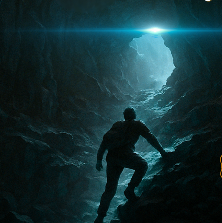 man seeking a light above a cave