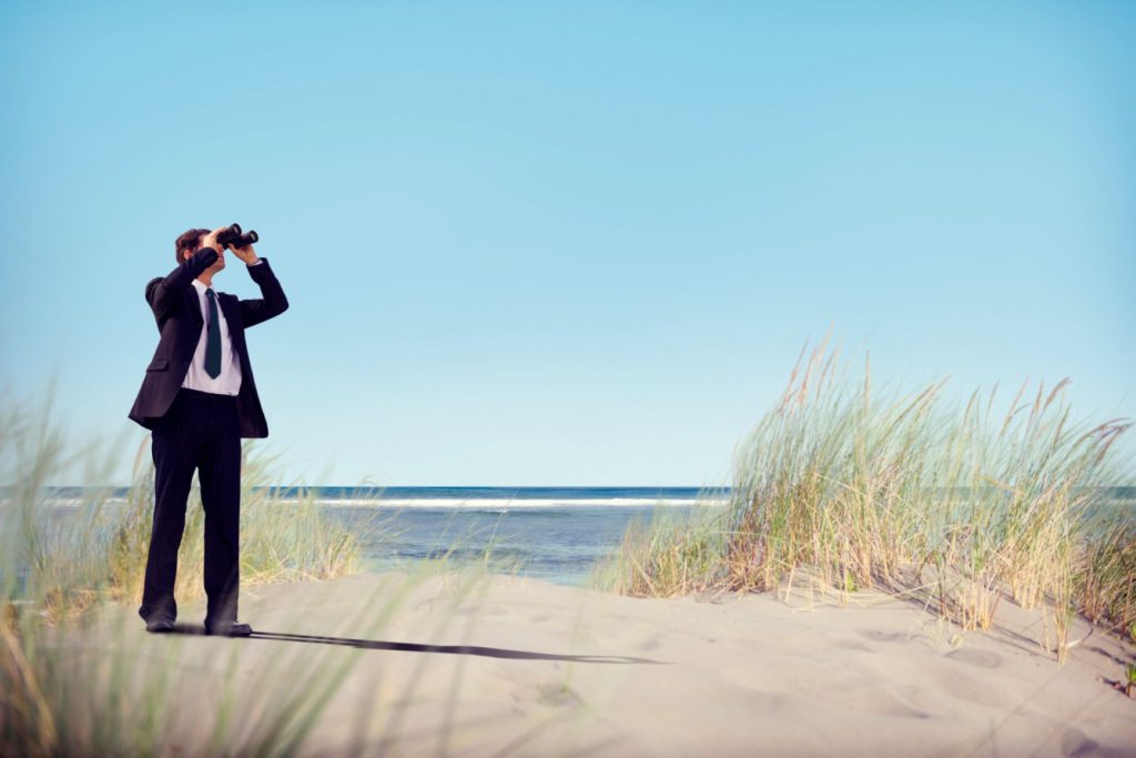 A man in search of something on the beach.