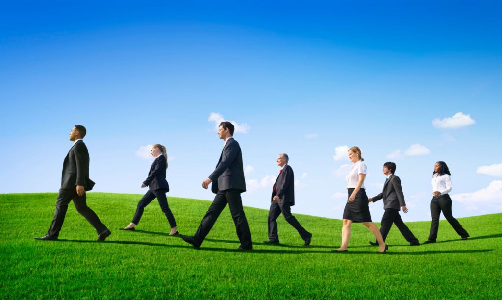 Leaders walking on green hills.